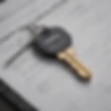 Close-up of a car key placed on a financial planning notebook