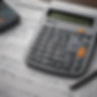 An overhead shot of a calculator, bank statements, and a leasing agreement.