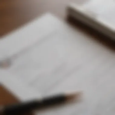 A close-up of grant application documents with a pen resting on top