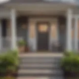 A modern home with a welcoming porch and a for sale sign in front.